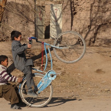 Afghan children play in a street in Herat, on January 14, 2013. (Aref Karimi/AFP/Getty Images)